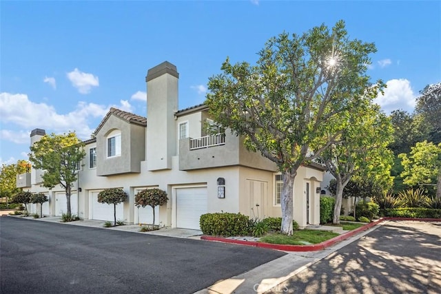81 Cloudcrest, Aliso Viejo, CA 92656 - multi unit property with an attached garage, a balcony, stucco siding, driveway, and a chimney