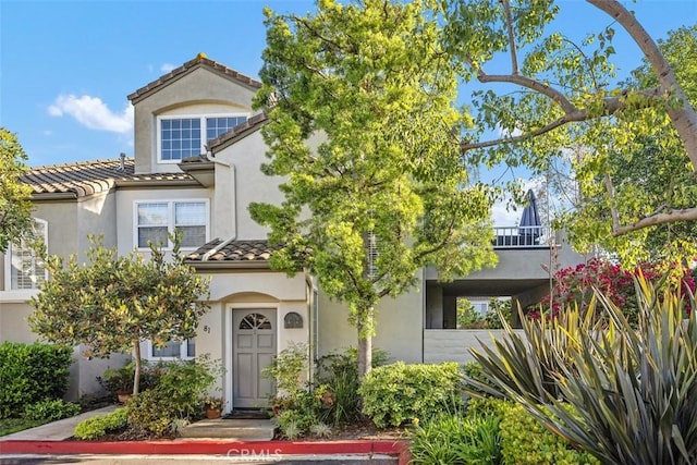 81 Cloudcrest, Aliso Viejo, CA 92656 - view of front facade with a tile roof, stucco siding, and a balcony