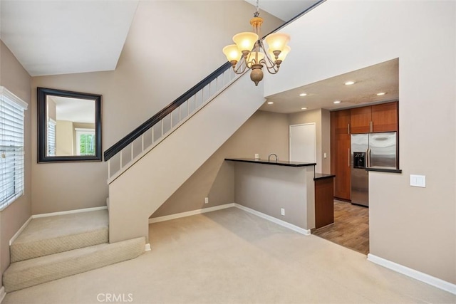 81 Cloudcrest, Aliso Viejo, CA 92656 - unfurnished living room featuring light carpet, baseboards, a chandelier, stairway, and recessed lighting