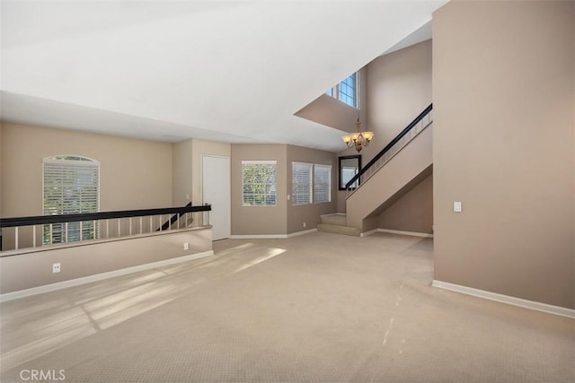 81 Cloudcrest, Aliso Viejo, CA 92656 - unfurnished living room featuring baseboards, carpet, and a chandelier