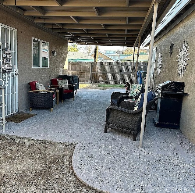 view of patio / terrace featuring fence and a grill