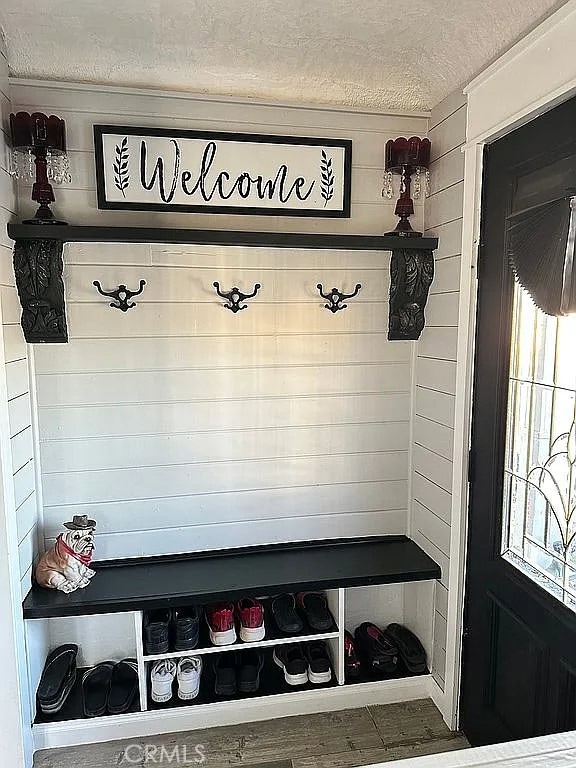 mudroom featuring a textured ceiling and plenty of natural light