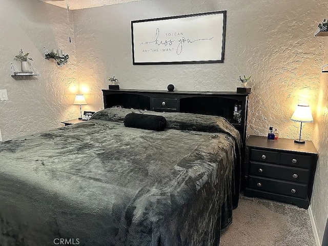 bedroom with a textured wall and carpet