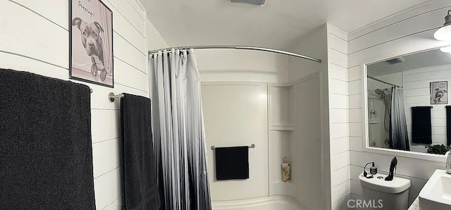bathroom with a shower with curtain and toilet