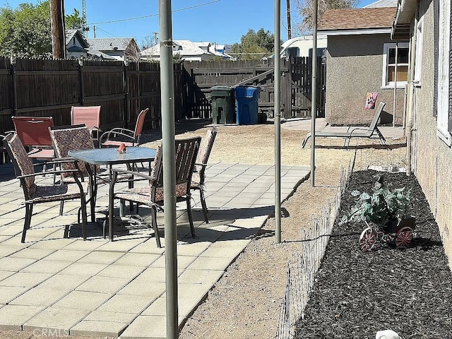 view of patio with a fenced backyard and outdoor dining area