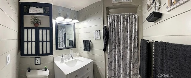 bathroom featuring tile walls, vanity, and a shower with shower curtain