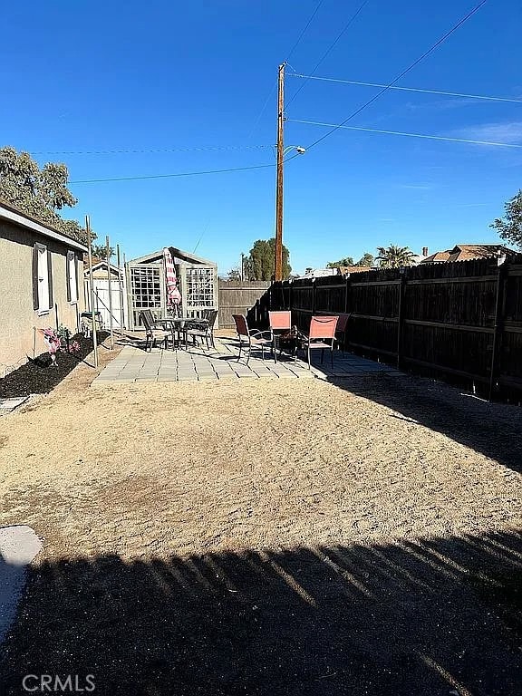 fenced backyard featuring a patio area