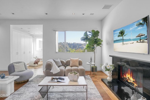1116 Linda Flora Dr, Los Angeles, CA 90049 - living room featuring wood finished floors and a warm lit fireplace