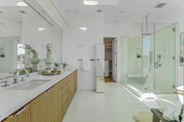 1116 Linda Flora Dr, Los Angeles, CA 90049 - bathroom with a shower stall, tile patterned flooring, double vanity, and a spacious closet