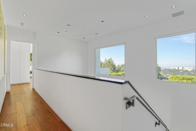 1116 Linda Flora Dr, Los Angeles, CA 90049 - hall with an upstairs landing, plenty of natural light, hardwood / wood-style floors, and recessed lighting