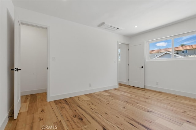 unfurnished room featuring light wood-style flooring, baseboards, and recessed lighting