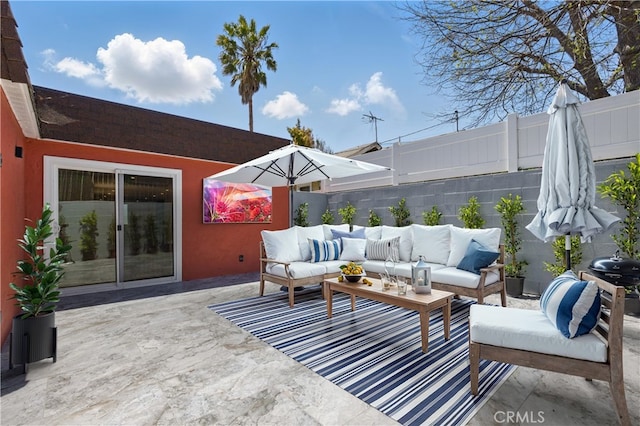 view of patio with an outdoor living space and fence