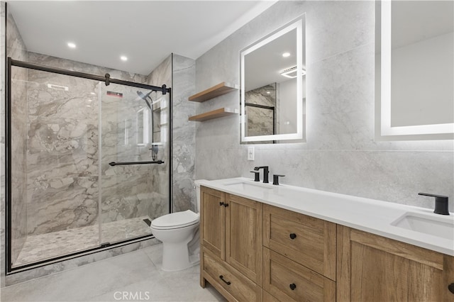 bathroom with toilet, a marble finish shower, tile walls, double vanity, and tile patterned floors