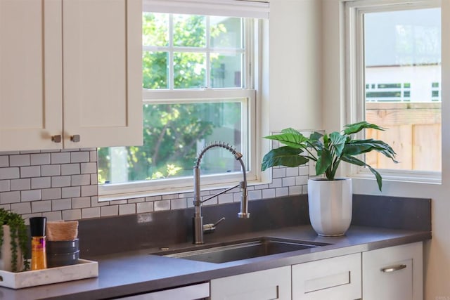 487678 34th St, San Diego, CA 92116 - kitchen featuring white cabinetry, tasteful backsplash, and dark countertops