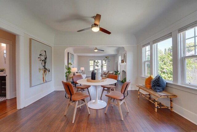 487678 34th St, San Diego, CA 92116 - dining area featuring healthy amount of natural light, a ceiling fan, dark wood-type flooring, and arched walkways