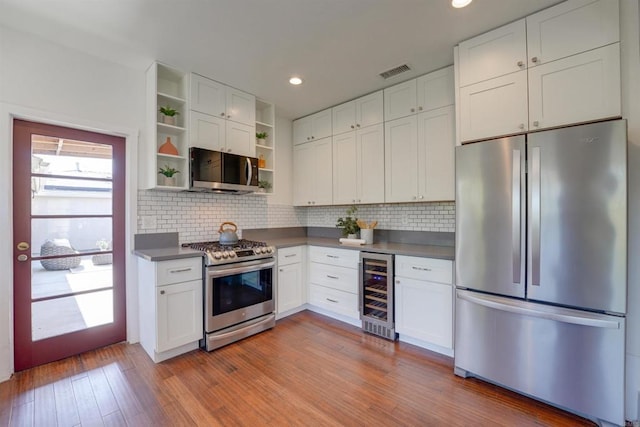 487678 34th St, San Diego, CA 92116 - kitchen with stainless steel appliances, beverage cooler, open shelves, white cabinets, and recessed lighting