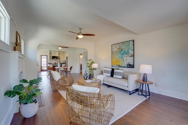 487678 34th St, San Diego, CA 92116 - living area featuring arched walkways, ceiling fan, and hardwood / wood-style floors