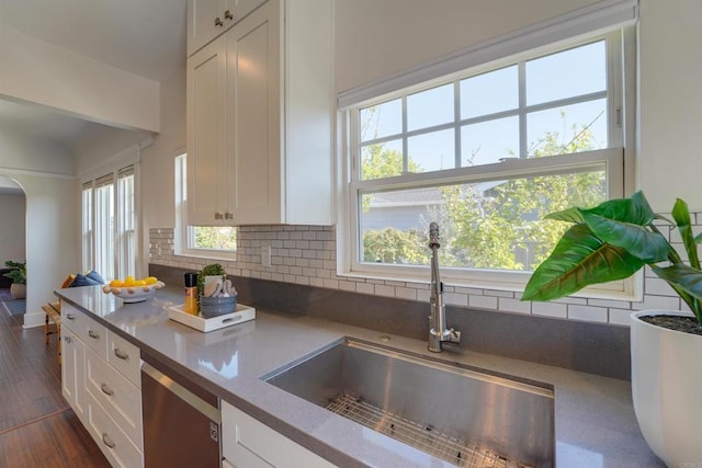 487678 34th St, San Diego, CA 92116 - kitchen with stainless steel dishwasher, white cabinets, decorative backsplash, and arched walkways