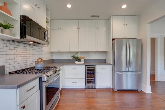 487678 34th St, San Diego, CA 92116 - kitchen with stainless steel appliances, wine cooler, open shelves, white cabinetry, and recessed lighting