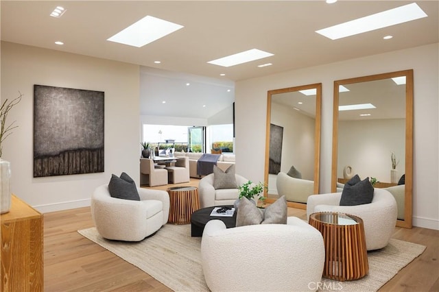 23262 Ellice Cir, Dana Point, CA 92629 - living room with a skylight, light wood-style flooring, recessed lighting, vaulted ceiling, and baseboards