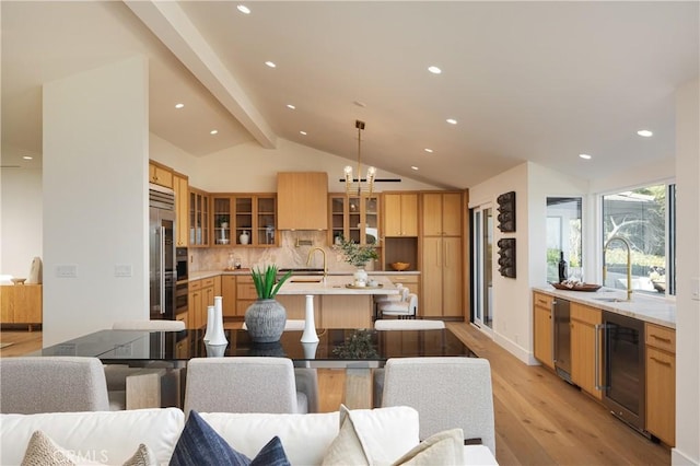 23262 Ellice Cir, Dana Point, CA 92629 - dining space featuring wine cooler, light wood-style flooring, recessed lighting, and a chandelier