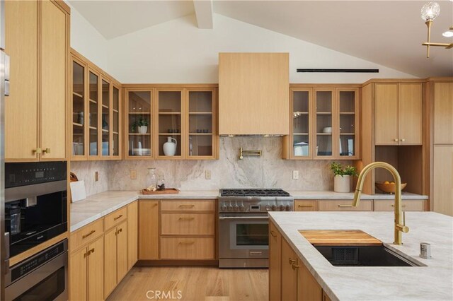 23262 Ellice Cir, Dana Point, CA 92629 - kitchen featuring high end stove, a sink, lofted ceiling, glass insert cabinets, and tasteful backsplash