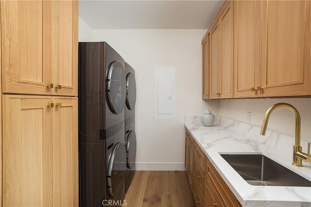 23262 Ellice Cir, Dana Point, CA 92629 - washroom with cabinet space, estacked washer and dryer, wood finished floors, baseboards, and electric panel