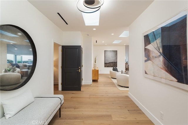 23262 Ellice Cir, Dana Point, CA 92629 - hallway with a skylight, light wood finished floors, and baseboards