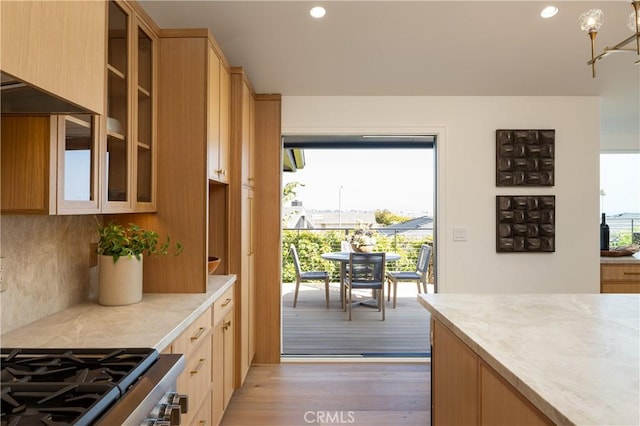 23262 Ellice Cir, Dana Point, CA 92629 - kitchen with light countertops, plenty of natural light, light wood-style floors, glass insert cabinets, and recessed lighting
