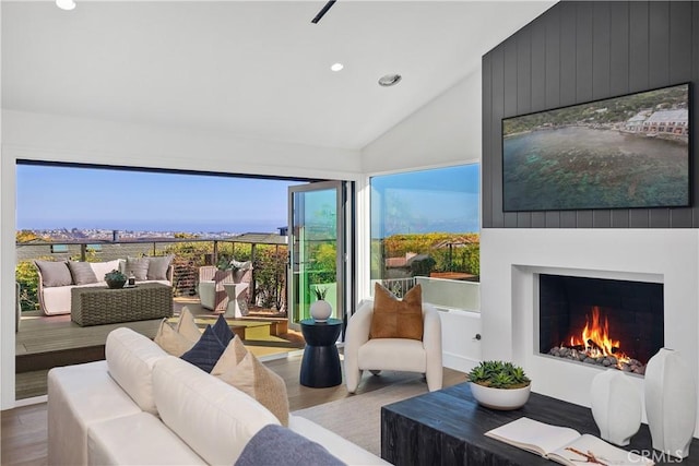 23262 Ellice Cir, Dana Point, CA 92629 - living room featuring lofted ceiling, recessed lighting, wood finished floors, and a large fireplace