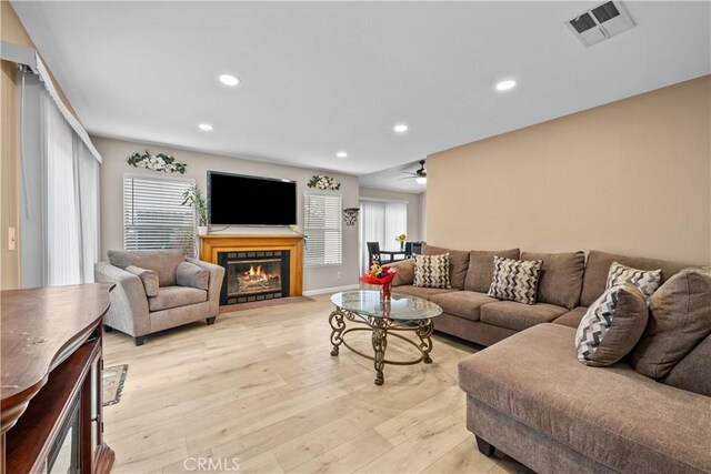 11483 Green Vly, Pacoima, CA 91331 - living room with light wood-type flooring, recessed lighting, a tile fireplace, a ceiling fan, and baseboards