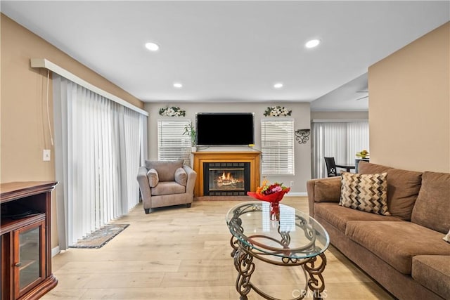 11483 Green Vly, Pacoima, CA 91331 - living area with light wood-style flooring, a glass covered fireplace, recessed lighting, and baseboards
