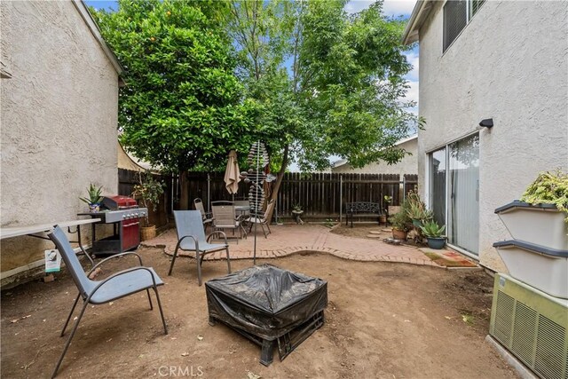11483 Green Vly, Pacoima, CA 91331 - view of patio featuring an outdoor fire pit, a fenced backyard, and outdoor dining space