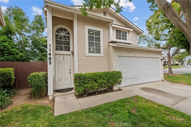 11483 Green Vly, Pacoima, CA 91331 - view of front of home with fence, driveway, and an attached garage