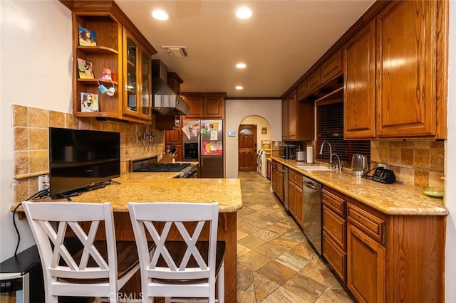 1731 W Kenneth Rd, Glendale, CA 91201 - kitchen with appliances with stainless steel finishes, wall chimney range hood, a sink, arched walkways, and tasteful backsplash