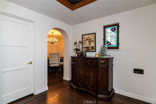 1731 W Kenneth Rd, Glendale, CA 91201 - hallway featuring arched walkways, a chandelier, dark wood-type flooring, and baseboards