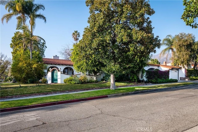 1731 W Kenneth Rd, Glendale, CA 91201 - mediterranean / spanish-style home with a chimney, a tiled roof, a garage, driveway, and stucco siding