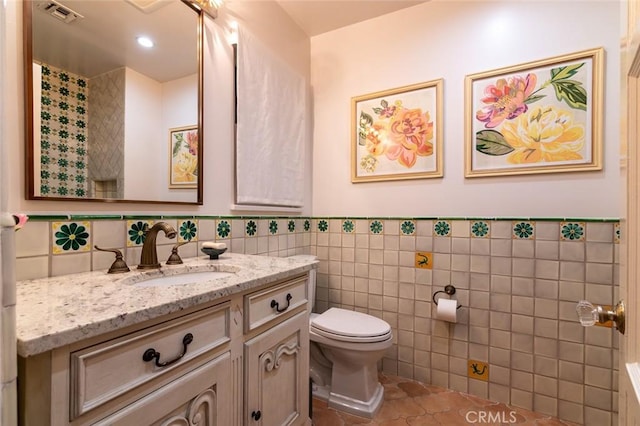 1731 W Kenneth Rd, Glendale, CA 91201 - bathroom with tile walls, toilet, tile patterned flooring, vanity, and a wainscoted wall