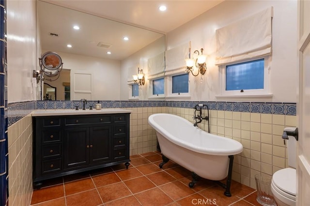 1731 W Kenneth Rd, Glendale, CA 91201 - bathroom featuring tile walls, tile patterned flooring, a freestanding tub, a wainscoted wall, and recessed lighting