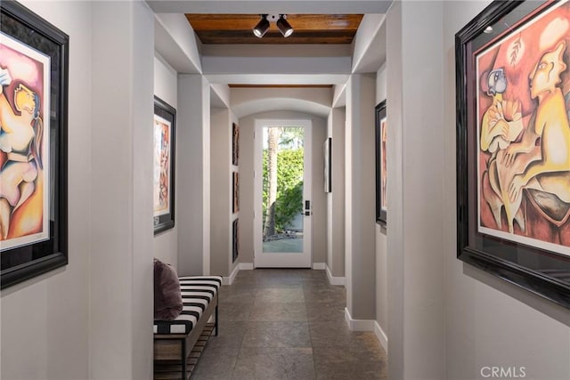 corridor featuring baseboards