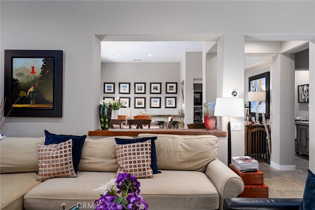 living area featuring baseboards and recessed lighting