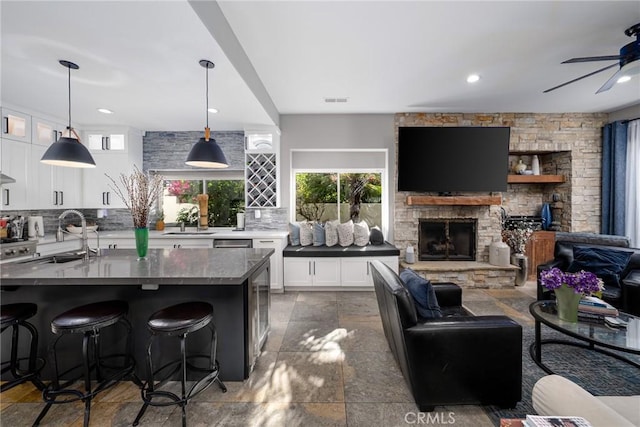 kitchen featuring a sink, decorative backsplash, white cabinets, and recessed lighting