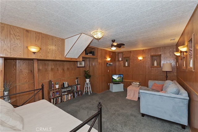 1027 Nesthorn Dr, Crestline, CA 92325 - living room with wood walls, ceiling fan, and carpet