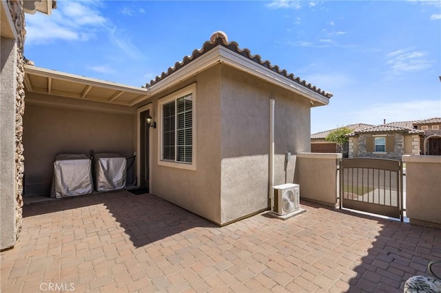 view of patio featuring a gate and ac unit