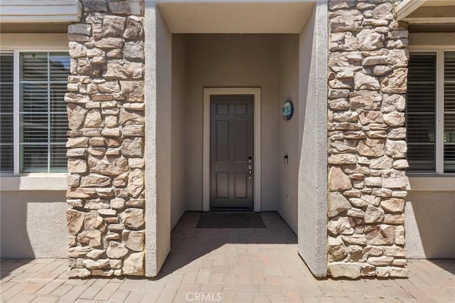 property entrance featuring stone siding