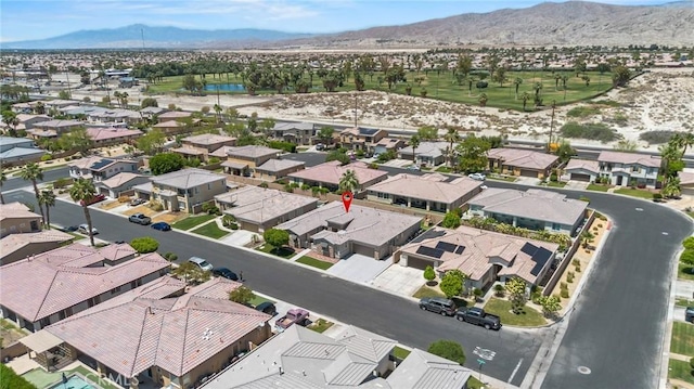 aerial view of property and surrounding area with nearby suburban area and a water and mountain view