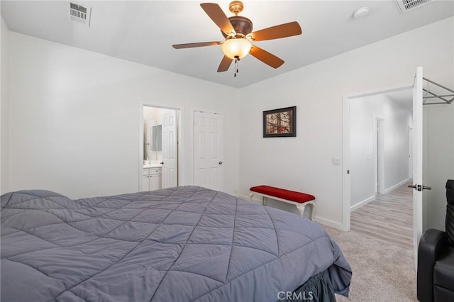 carpeted bedroom featuring baseboards, ceiling fan, and connected bathroom