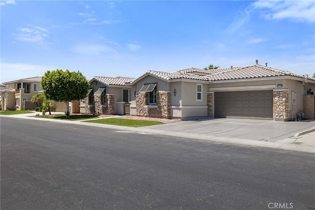 view of front facade featuring stone siding, stucco siding, an attached garage, and driveway