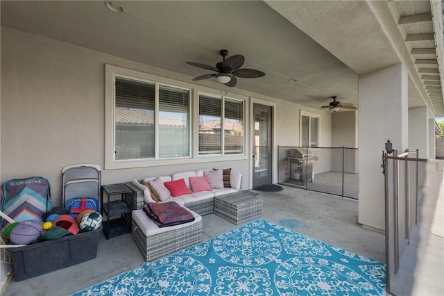view of patio with ceiling fan and an outdoor living space