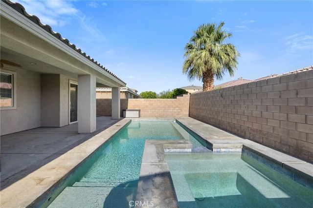 view of pool featuring a fenced backyard, a patio, and a pool with connected hot tub